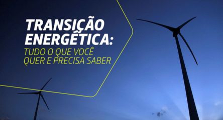 Turbinas eólicas vistas contra o céu azul, representando energia renovável e transição energética.
